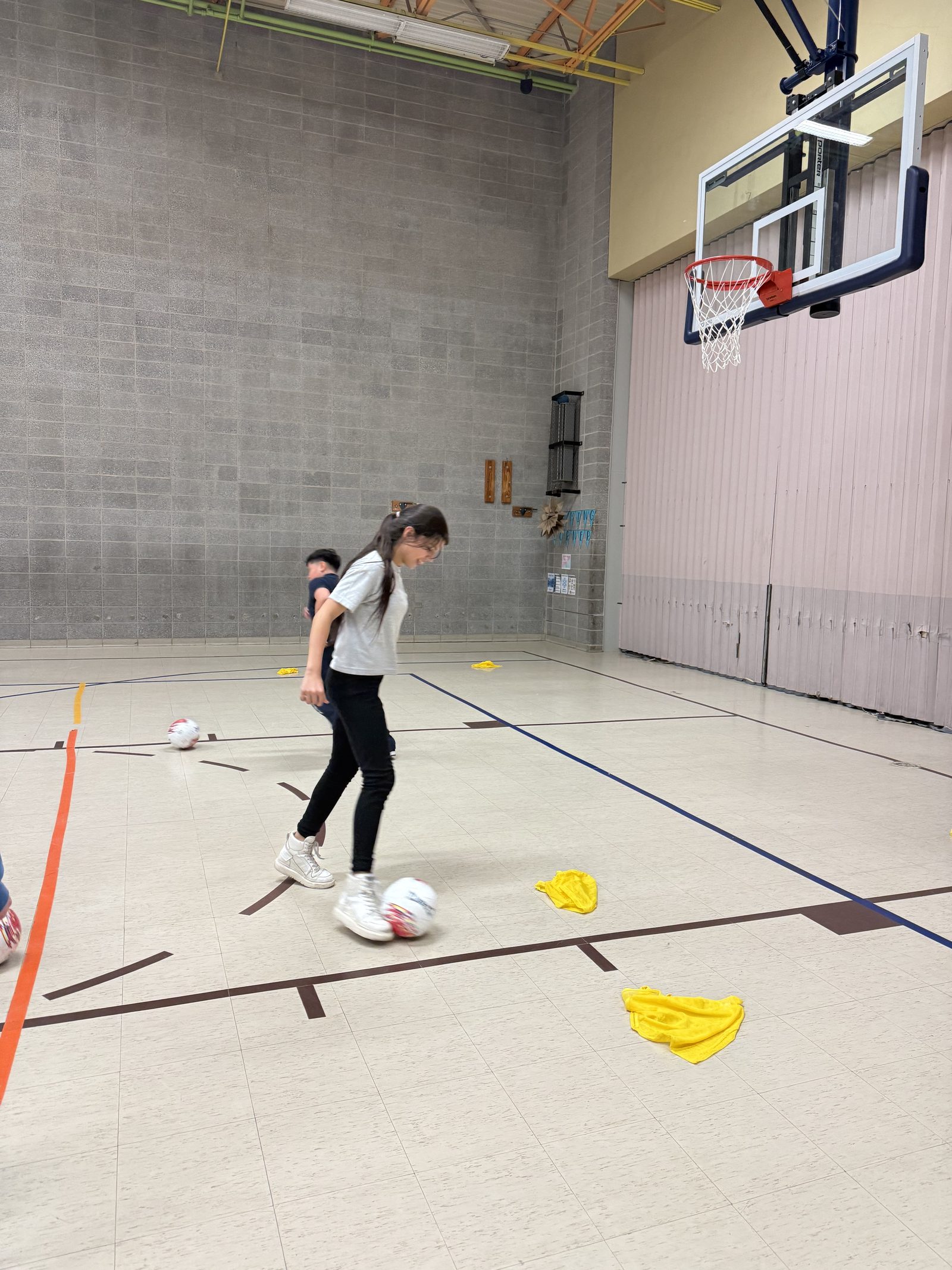 A girl dribbling a soccer ball