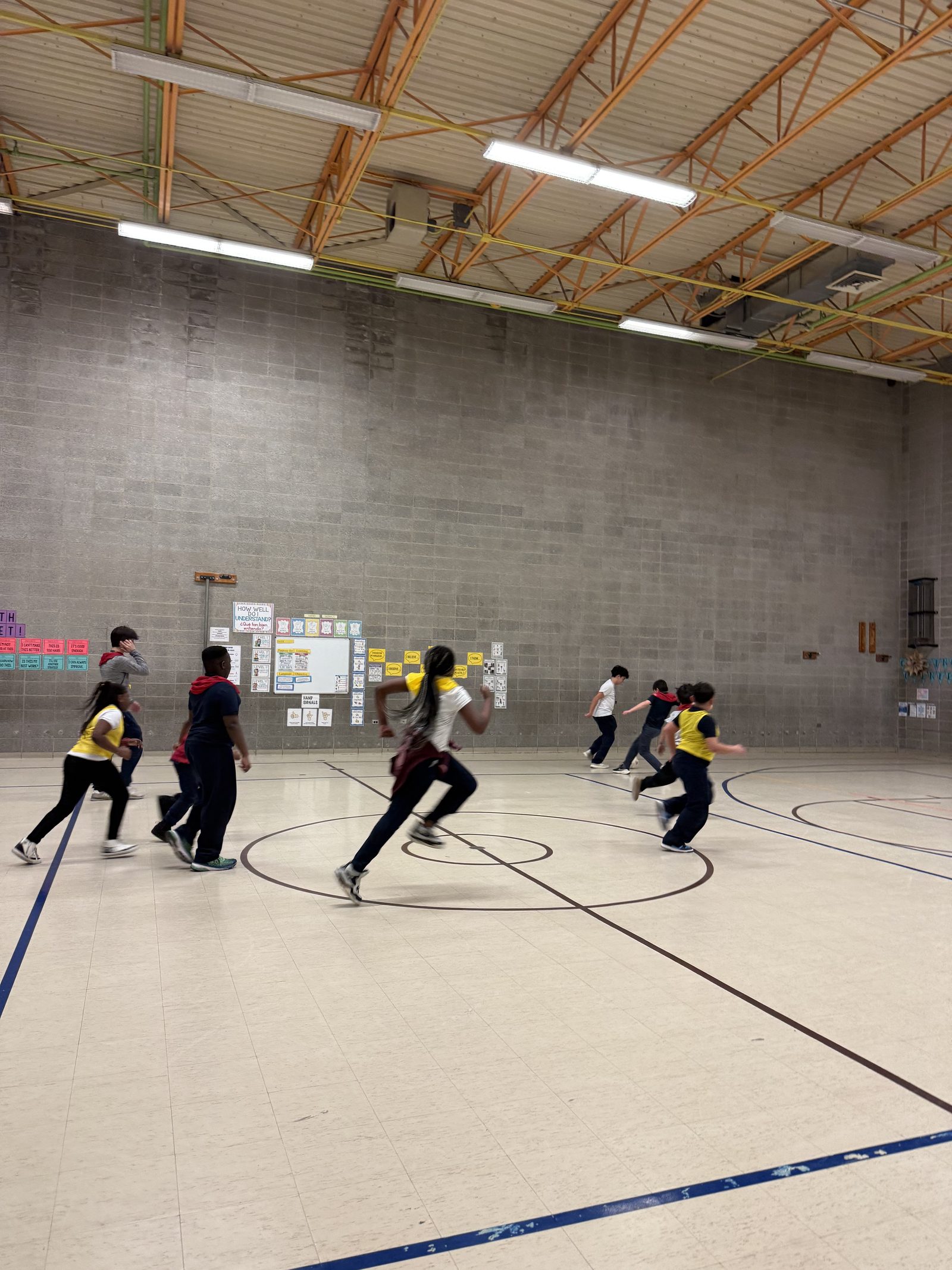 Kids running across the court in a drill